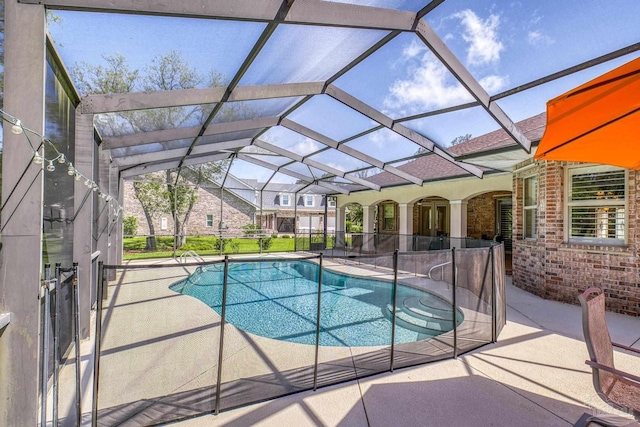 outdoor pool featuring a patio and glass enclosure