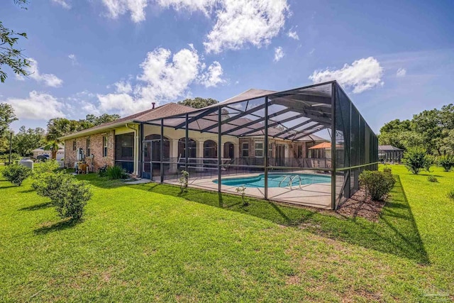 outdoor pool featuring a yard, glass enclosure, and a patio area