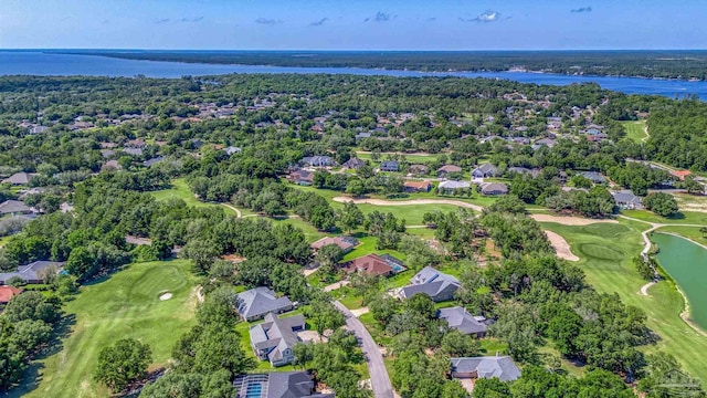 aerial view of residential area featuring a local golf course and a nearby body of water
