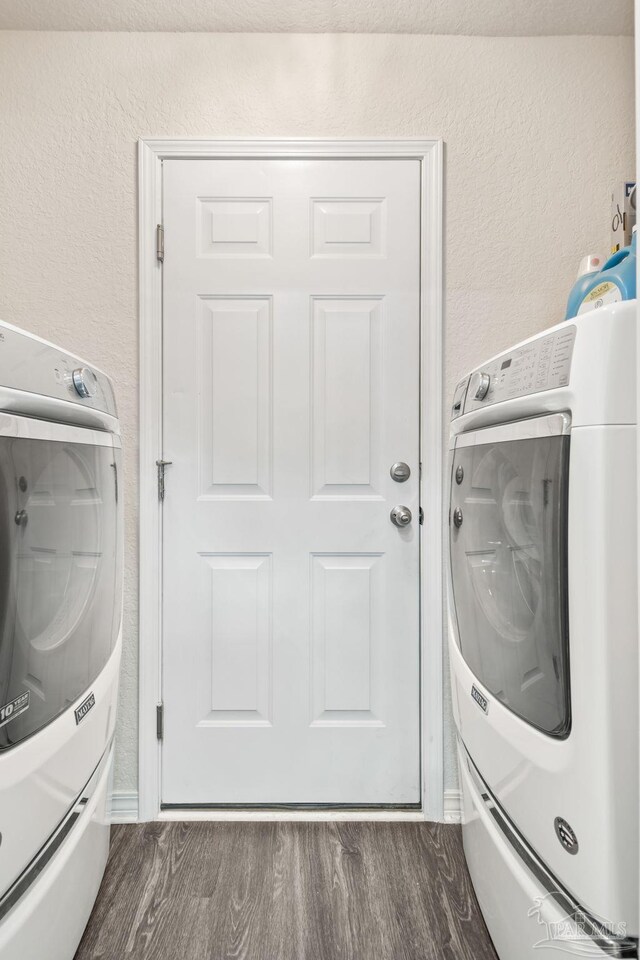 laundry room featuring dark hardwood / wood-style flooring and washing machine and dryer