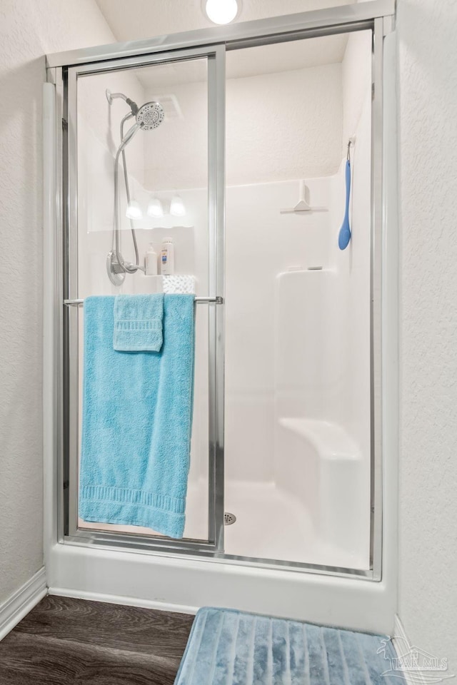 bathroom featuring hardwood / wood-style floors and walk in shower