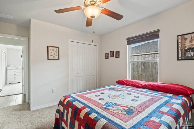 carpeted bedroom with a closet and ceiling fan