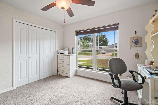 carpeted office featuring ceiling fan