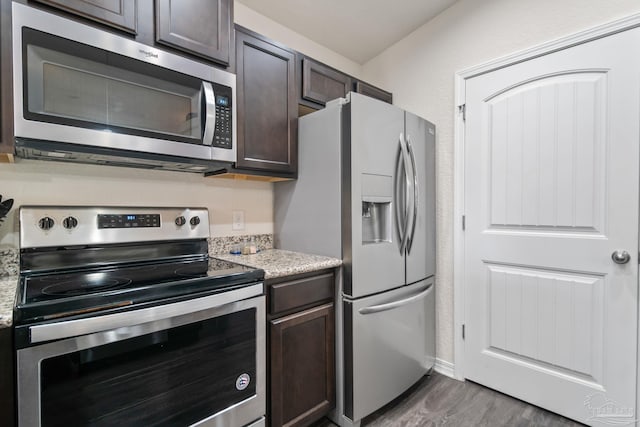 kitchen featuring stainless steel appliances, dark hardwood / wood-style floors, and dark brown cabinetry