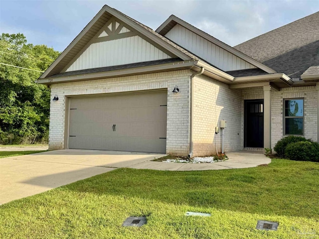 720 Brambling Ct, Cantonment, FL 32533 - view of front of home featuring brick siding, a garage, a front yard, and roof with shingles