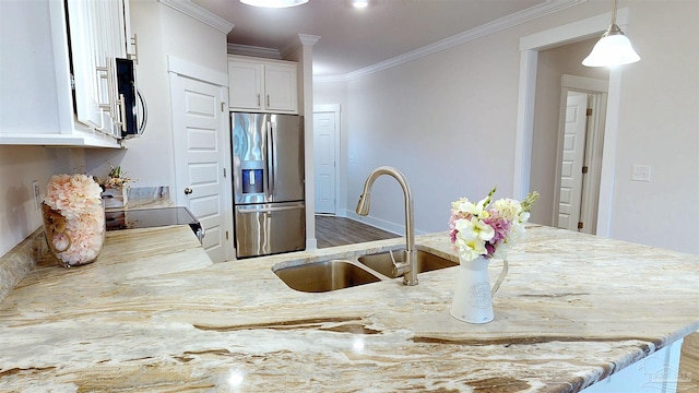 720 Brambling Ct, Cantonment, FL 32533 - kitchen with stainless steel appliances, a sink, ornamental molding, light stone counters, and white cabinets