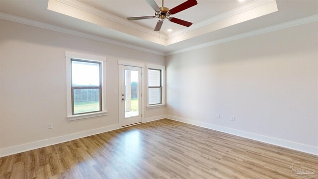 720 Brambling Ct, Cantonment, FL 32533 - empty room featuring light wood finished floors, a raised ceiling, baseboards, ornamental molding, and ceiling fan