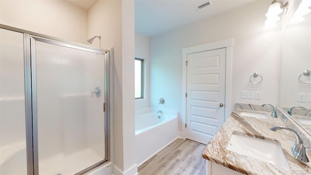 720 Brambling Ct, Cantonment, FL 32533 - full bath with a shower stall, a garden tub, double vanity, wood finished floors, and a chandelier