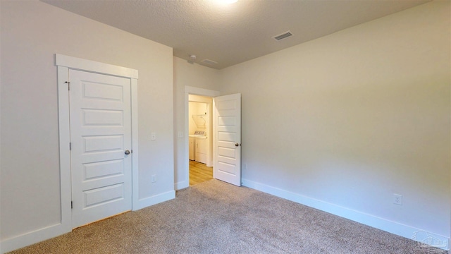 720 Brambling Ct, Cantonment, FL 32533 - unfurnished bedroom with carpet flooring, baseboards, washer / clothes dryer, and a textured ceiling