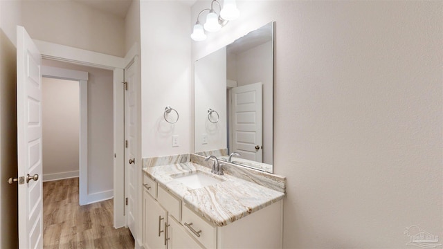 720 Brambling Ct, Cantonment, FL 32533 - bathroom with vanity, wood finished floors, and baseboards
