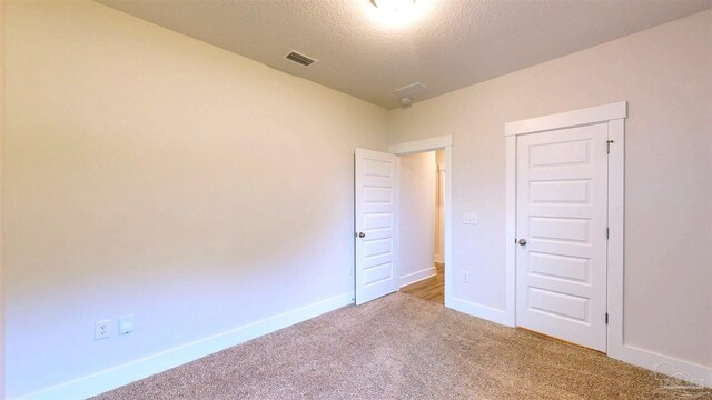 720 Brambling Ct, Cantonment, FL 32533 - unfurnished bedroom with carpet flooring, a textured ceiling, and baseboards