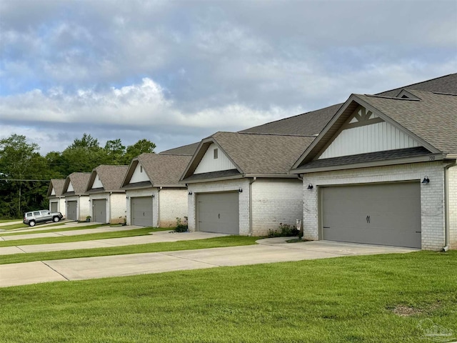 720 Brambling Ct, Cantonment, FL 32533 - view of front facade with brick siding, a front yard, roof with shingles, and driveway