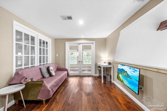 living room with french doors and dark wood-type flooring