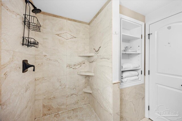 bathroom with a tile shower