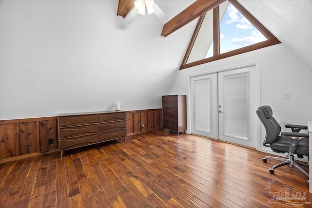 office area with french doors, lofted ceiling with beams, wooden walls, and dark hardwood / wood-style floors