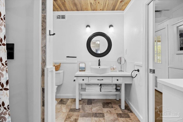 bathroom with toilet, vanity, and wood ceiling