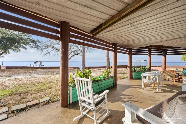 view of patio with a water view