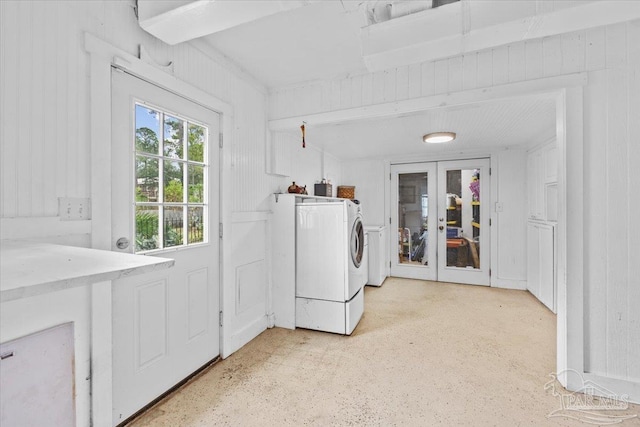 clothes washing area with french doors and separate washer and dryer