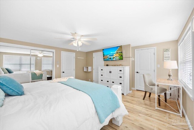 bedroom featuring ceiling fan, multiple windows, and light hardwood / wood-style flooring