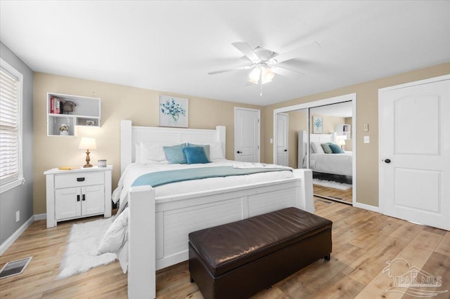 bedroom featuring light hardwood / wood-style flooring, ceiling fan, and a closet