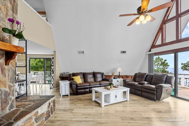 living room with high vaulted ceiling, light hardwood / wood-style floors, and ceiling fan