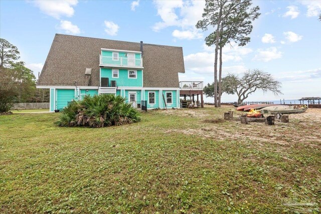 rear view of property featuring a lawn