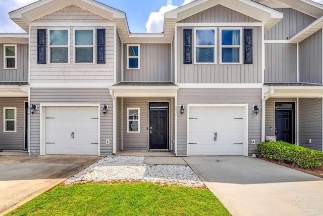 6004 Royal Port Ct, Pensacola, FL 32526 - view of property with an attached garage, driveway, and board and batten siding