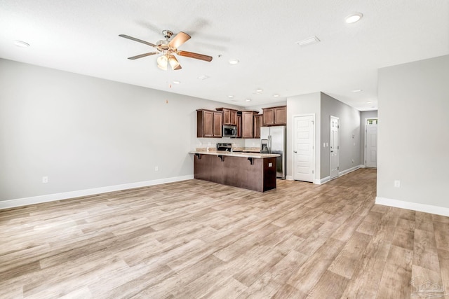 6004 Royal Port Ct, Pensacola, FL 32526 - unfurnished living room featuring a ceiling fan, recessed lighting, and light wood-type flooring