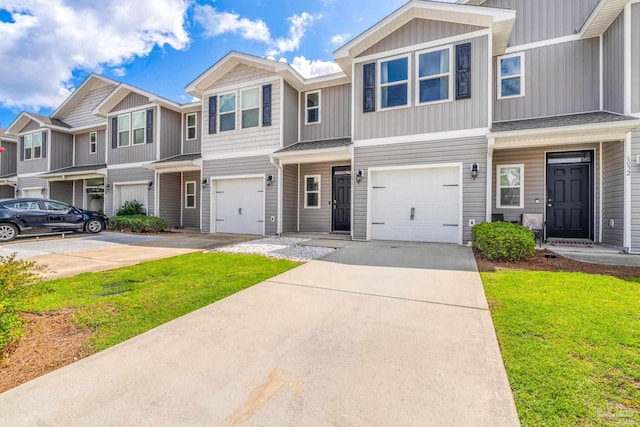 6004 Royal Port Ct, Pensacola, FL 32526 - view of property with concrete driveway, an attached garage, a front yard, and board and batten siding