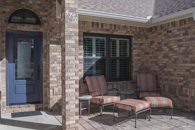 entrance to property featuring a patio area