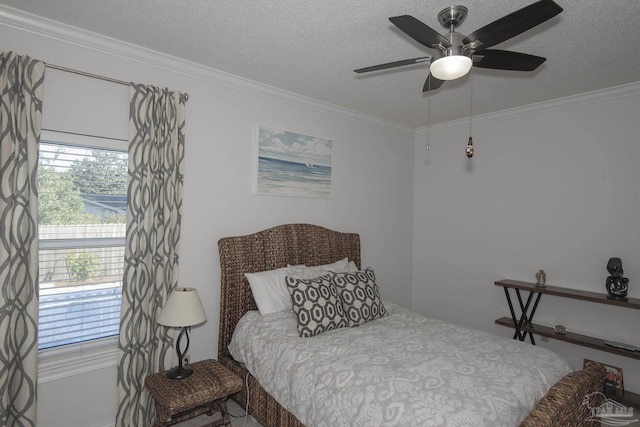 bedroom featuring ceiling fan, a textured ceiling, and ornamental molding