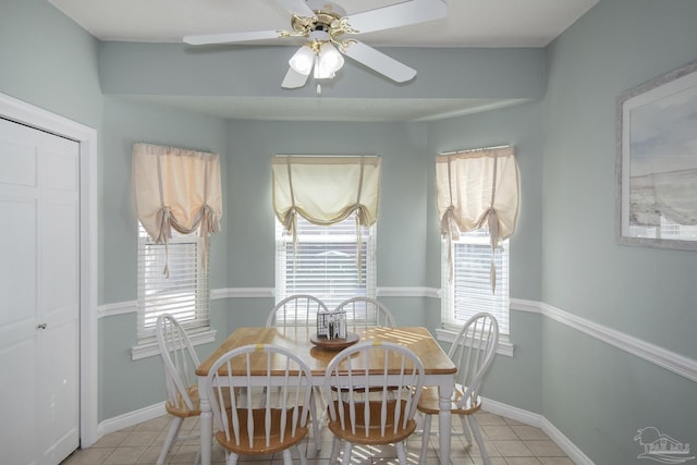 tiled dining space with ceiling fan