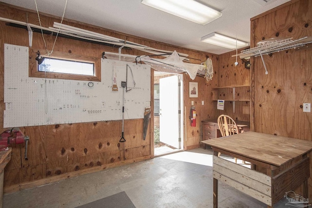 basement featuring a workshop area and wooden walls