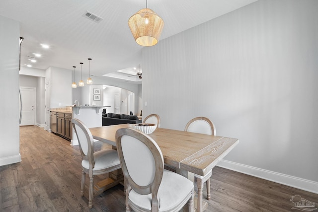 7908 Majestic Cypress Dr, Milton, FL 32583 - dining room with arched walkways, baseboards, ceiling fan, and wood finished floors