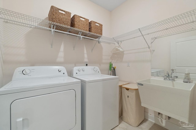 7908 Majestic Cypress Dr, Milton, FL 32583 - washroom featuring a sink, separate washer and dryer, light tile patterned floors, and laundry area