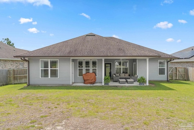 7908 Majestic Cypress Dr, Milton, FL 32583 - back of property with roof with shingles, an outdoor hangout area, a fenced backyard, a patio area, and a lawn