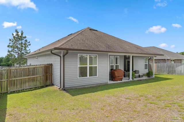 7908 Majestic Cypress Dr, Milton, FL 32583 - rear view of house with a yard, a shingled roof, a fenced backyard, and a patio area