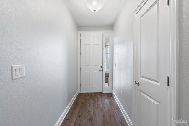 7908 Majestic Cypress Dr, Milton, FL 32583 - doorway to outside featuring baseboards and dark wood-style floors