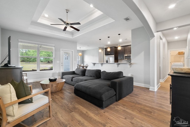 7908 Majestic Cypress Dr, Milton, FL 32583 - living room featuring ceiling fan, visible vents, arched walkways, light wood-type flooring, and baseboards