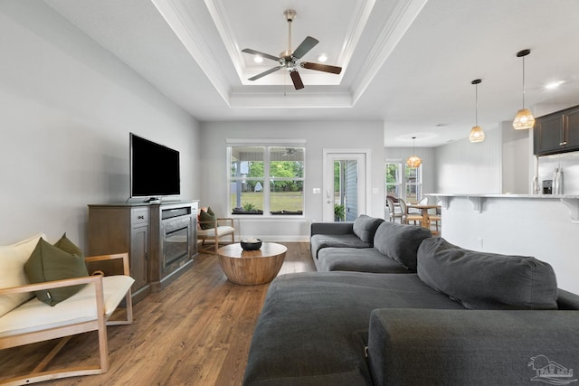 7908 Majestic Cypress Dr, Milton, FL 32583 - living area with crown molding, a ceiling fan, recessed lighting, wood finished floors, and a tray ceiling