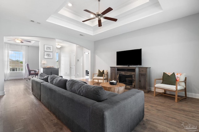 7908 Majestic Cypress Dr, Milton, FL 32583 - living area with visible vents, arched walkways, a raised ceiling, and ceiling fan