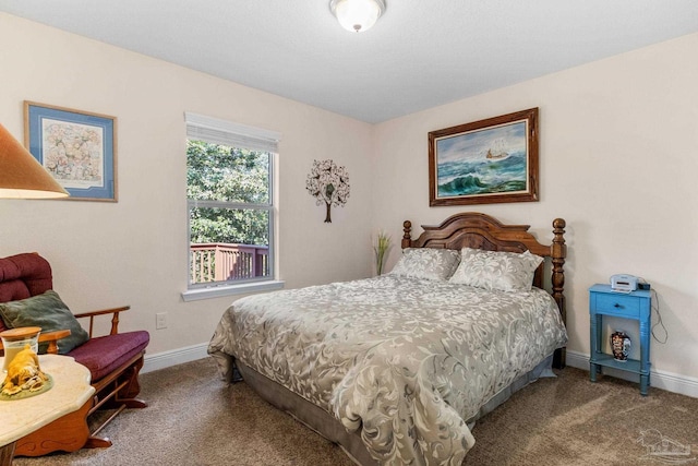 bedroom with baseboards and carpet