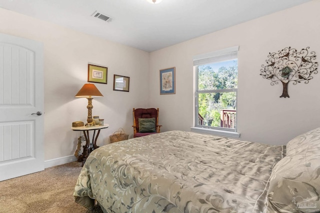 bedroom featuring baseboards, carpet flooring, and visible vents
