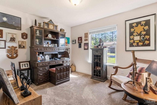 home office featuring light carpet and baseboards