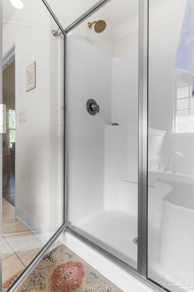 bathroom with tile patterned floors and a stall shower