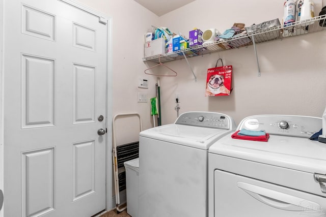 clothes washing area featuring washing machine and clothes dryer and laundry area