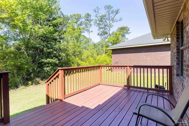 wooden deck featuring a lawn