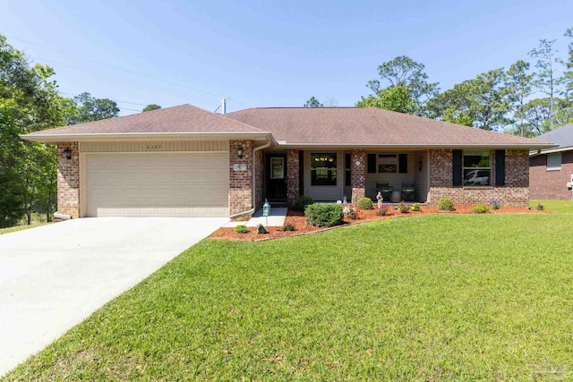 single story home featuring an attached garage, brick siding, a front yard, and concrete driveway