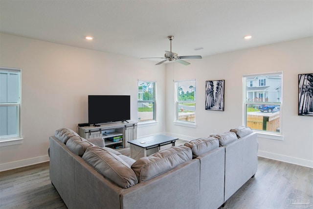 living room featuring light hardwood / wood-style floors and ceiling fan