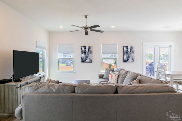 living room featuring ceiling fan and hardwood / wood-style flooring